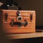 brown suitcase on top of table