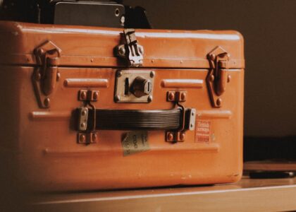 brown suitcase on top of table