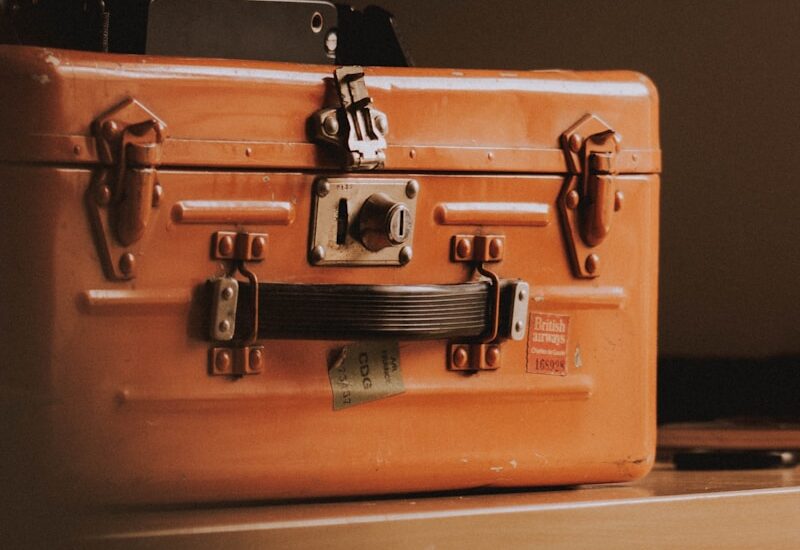 brown suitcase on top of table